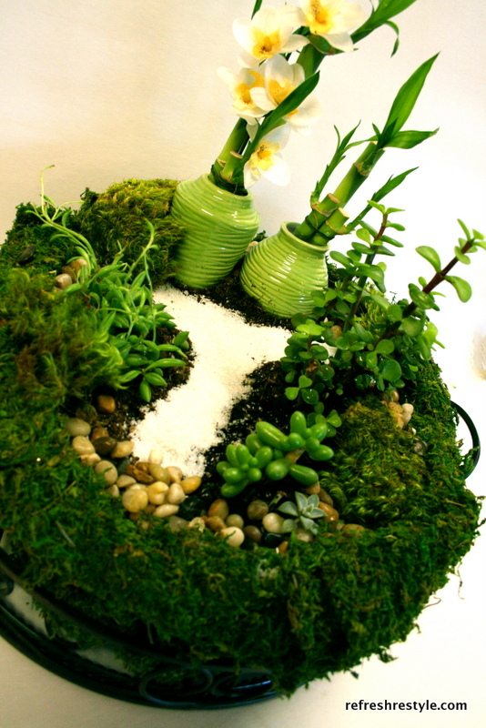 Using sand to create a path in a mini fairy garden.