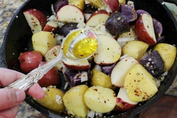 Add olive oil to the potatoes