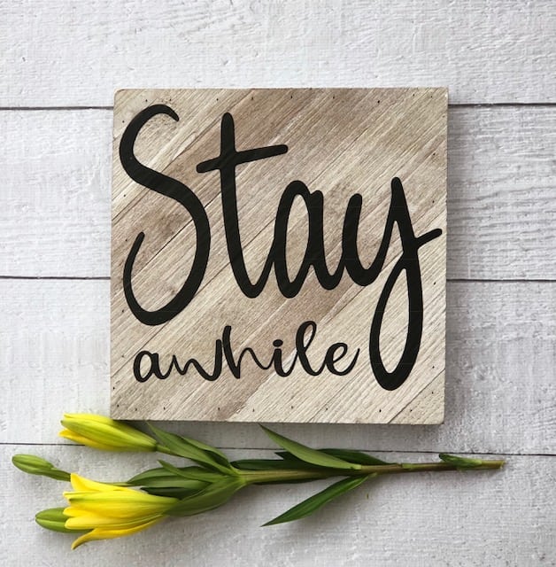 DIY this Stay A While Sign - popular farmhouse sign. It's easy with a vinyl cutting machine.